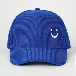 Macro detail of blue corduroy baseball cap texture with white smile embroidery