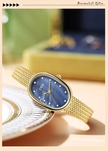 Detail of gold oval watch with blue mother-of-pearl dial and vintage mesh strap