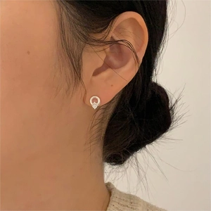 Close-up of 925 sterling silver geometric stud earring with a sparkling zircon stone