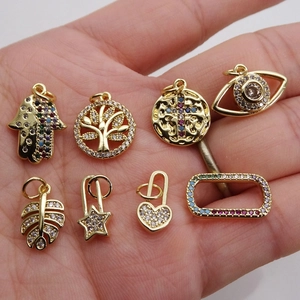 8 mixed gold-plated micro-pave zircon charms including Hamsa, Tree of Life, and Evil Eye
