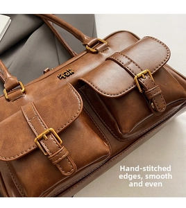 Detail shot of vintage brown tote bag showing manual stitching and smooth leather texture