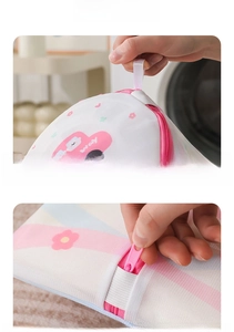 Detail of floral laundry bag with pink zipper and lanyard for washing protection