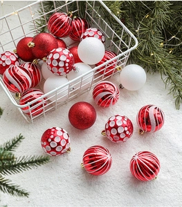 Detailed view of red and white 6cm painted Christmas balls in a white wire basket
