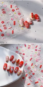 Close-up of Lunar New Year nail stickers with 3D embossed rabbit and lantern motifs