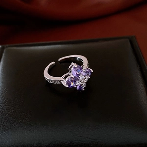 Macro shot of silver ring with purple heart crystals and white cubic zirconia details