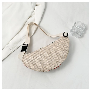 Detail of beige straw woven fanny pack showing textured pattern and adjustable buckle