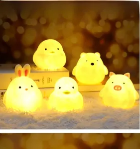 Detailed set of five cartoon animal night lights with warm yellow glow on soft white carpet