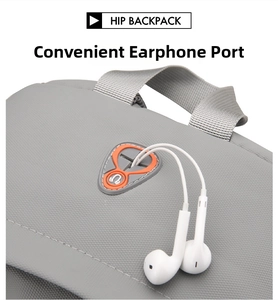 Detail of grey backpack featuring a functional headphone port with orange silicone trim