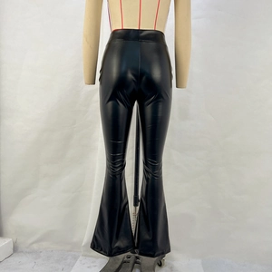 Dettaglio dei pantaloni a zampa in pelle PU nera lucida a vita alta su un manichino