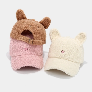 Texture detail of plush fleece baseball caps with rabbit ears and heart embroidery