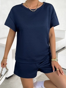 Detailed view of dark blue two-piece set featuring geometric knit texture and elastic waist