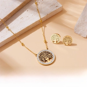 Macro detail of Tree of Life jewelry set with sparkling crystals on textured stone