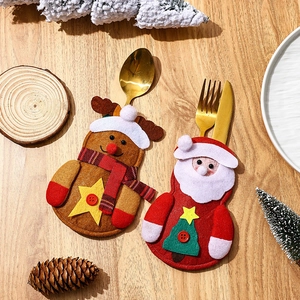 Christmas Santa and Reindeer felt cutlery holders set on wooden table with decor