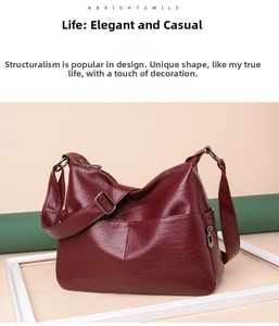 Detail of wine red tote bag with oil wax leather texture and metal side zipper pocket