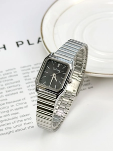 Macro detail of silver stainless steel watch strap and black square dial with GoGoey logo