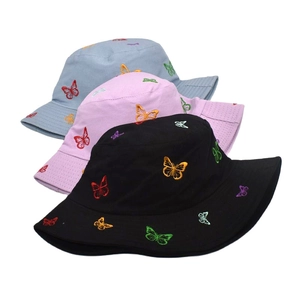 Detailed embroidery of colorful butterflies on cotton canvas bucket hats in three colors