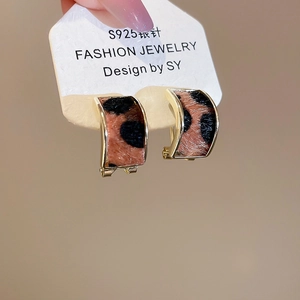 Detailed close-up of leopard print C-shape earrings with gold trim and S925 silver needles