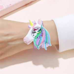Close-up of a child wearing a colorful cartoon unicorn silicone slap watch in white