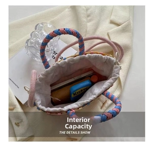 Detail view of woven bucket bag interior showing phone and storage capacity
