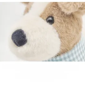 Close-up of plush Fox Terrier toy dog with soft long fur and blue checkered bandana