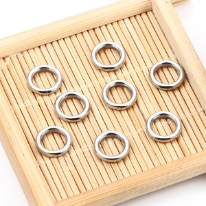 Polished silver stainless steel jump rings on bamboo mat for jewelry making DIY