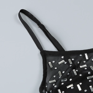 Macro detail of sheer black mesh top featuring silver rhinestones and adjustable straps