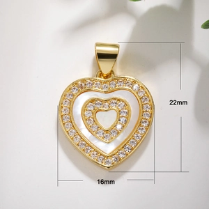 Detail shot of heart-shaped shell pendant with 22mm by 16mm dimensions and gold plating