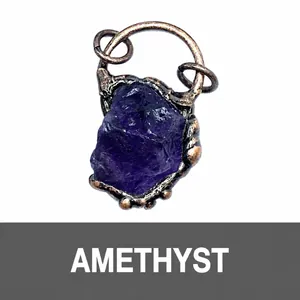 Macro shot of natural raw amethyst stone pendant with vintage bronze metal wrap detailing