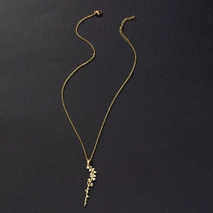 Detail of gold stainless steel necklace featuring a custom Sophia name flower pendant