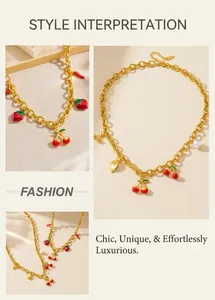 Detail of gold chain necklace with enamel cherry, strawberry and pearl pendants