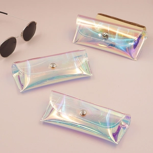 Macro detail of holographic PVC sunglass pouches with silver metal button closures