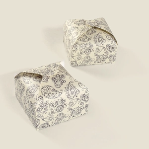 Detail of vintage beige gift boxes featuring elegant blue paisley patterns and pyramid tops