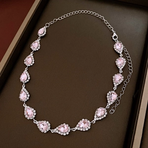 Detail of silver-tone necklace with pink pear-cut crystals and halo rhinestones in a gift box