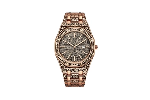 Macro shot of rose gold octagon watch featuring intricate Arabic pattern engravings