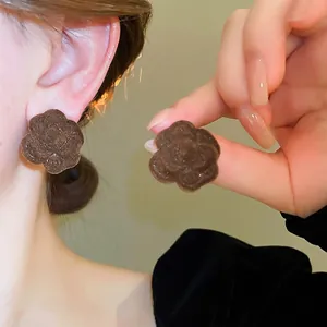 Brown flocked camellia flower stud earrings with metal logo for elegant daily wear