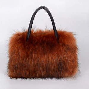 Detail of plush brown faux fur texture and black PU leather handle on the tote bag