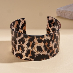 Detailed close-up of acrylic wide open cuff bangle with classic leopard print pattern