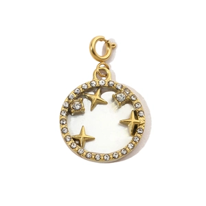 Detail of round shell pendant with gold star relief and sparkling crystal halo
