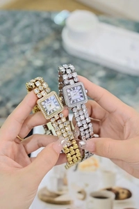 Macro detail of square roman dial watch set in gold and silver with crystal accents