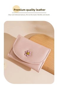 Close-up of pink litchi grain leather tri-fold wallet with a 3D purple daisy flower