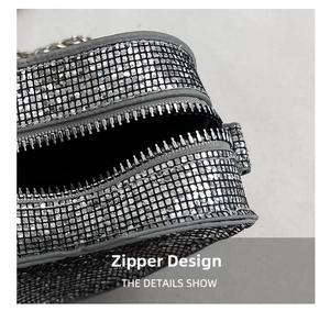 Detailed close-up of a silver sequined heart bag showing smooth metal zipper hardware