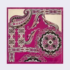 Detailed flat lay of large square silk scarf with paisley and mandala patterns