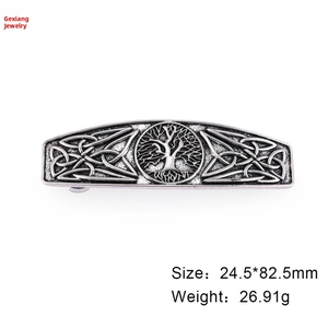 Detailed close-up of antique silver tree of life barrette with Celtic knot pattern