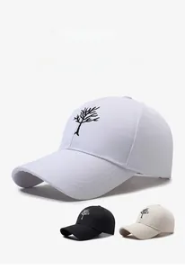 Close-up of tree embroidery detail on cotton baseball caps in white, black and beige
