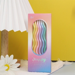 Close-up of wavy pastel birthday candles in six gradient colors with decorative packaging