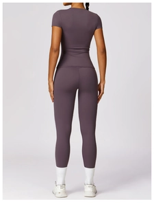 Detail showing high-waist yoga leggings and slim fit short sleeve top in purple and mauve