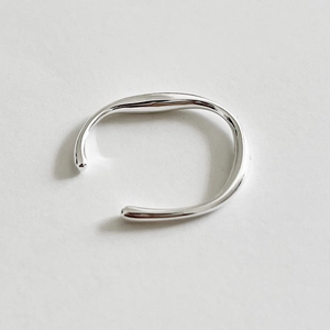 Detailed view of polished sterling silver ring with irregular fluid curved design
