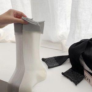 Close-up of ballet-style sheer crew socks with fine ribbed texture in neutral colors