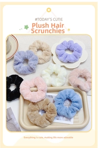 Detail of plush faux fur oversized scrunchies in soft pastel macaron colors