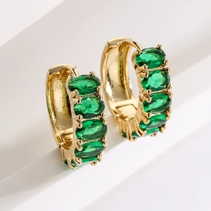 Elegant gold-plated hoop earrings with oval green zircons on a white tiered background